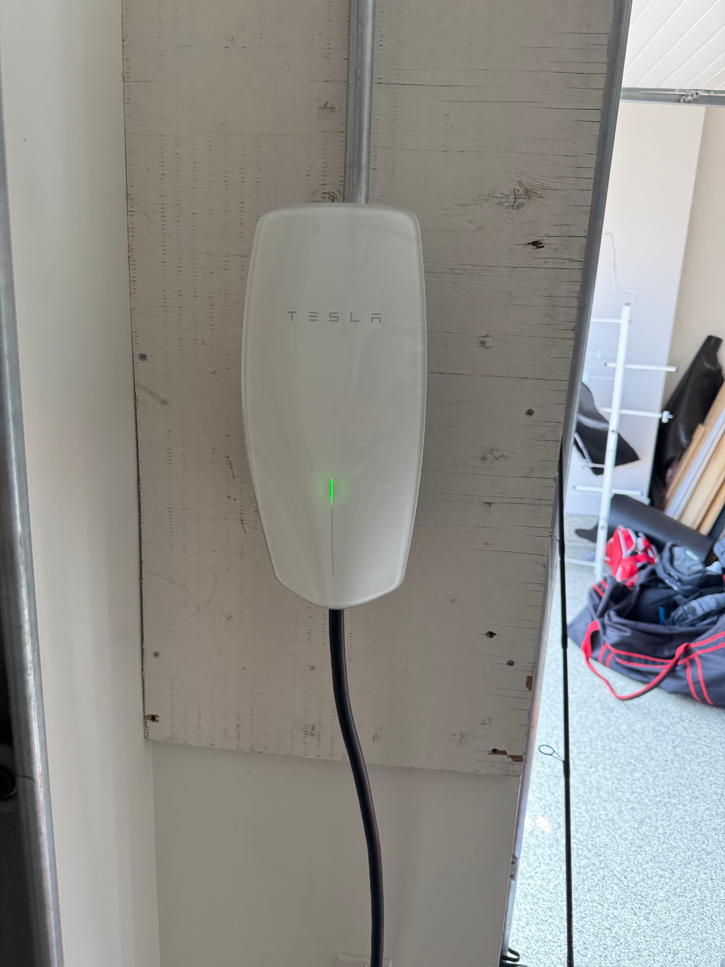 Tesla wall connector installed in a garage
