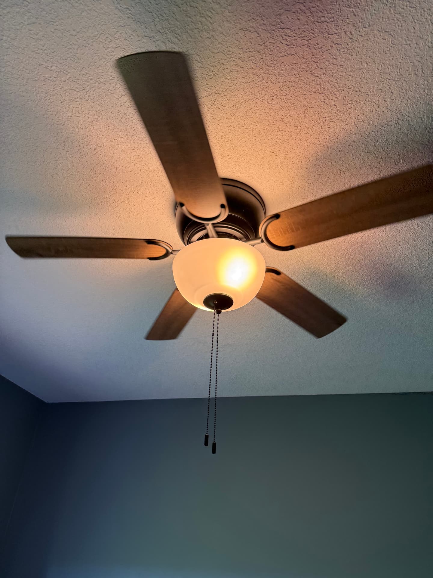Ceiling fan with integrated light installed and operating